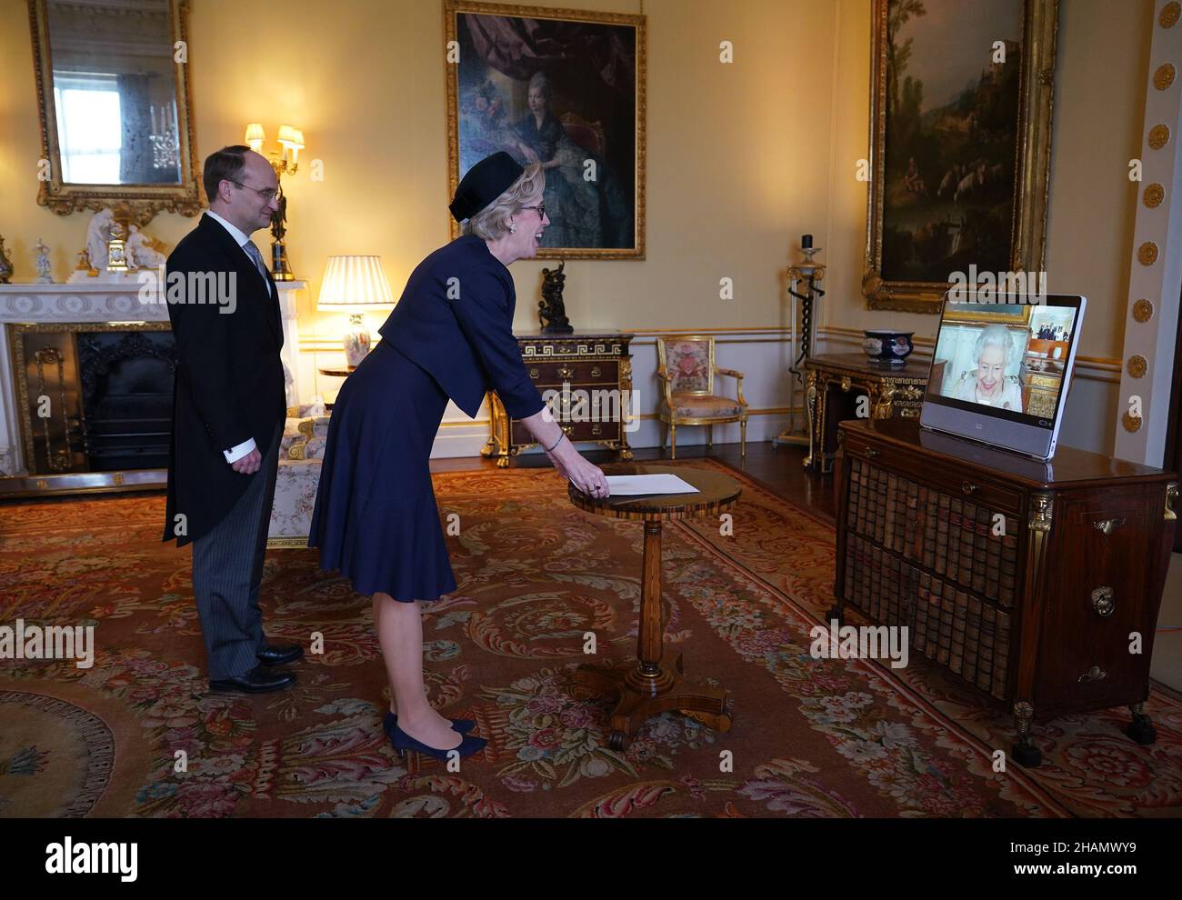 Queen Elizabeth II appears on a screen via videolink from Windsor Castle, where she is in residence, during a virtual audience to receive Mikaela Kumlin Granit, the Ambassador from the Kingdom of Sweden, and her husband Jakob Granit, at Buckingham Palace, London. Picture date: Tuesday December 14, 2021. Stock Photo