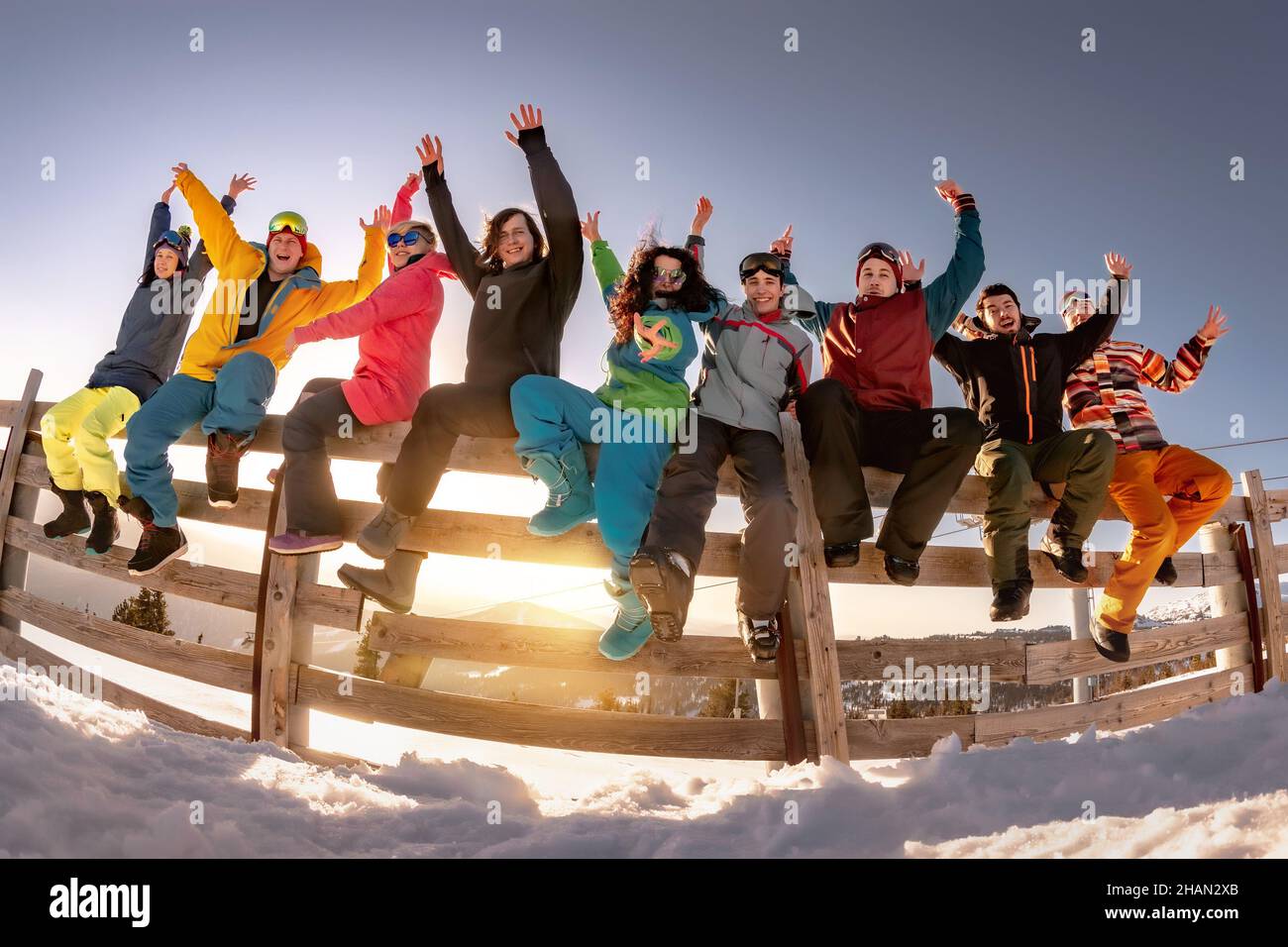 Group of happy friends skiers and snowboarders on holidays. Concept winter active sport weekend. Stock Photo