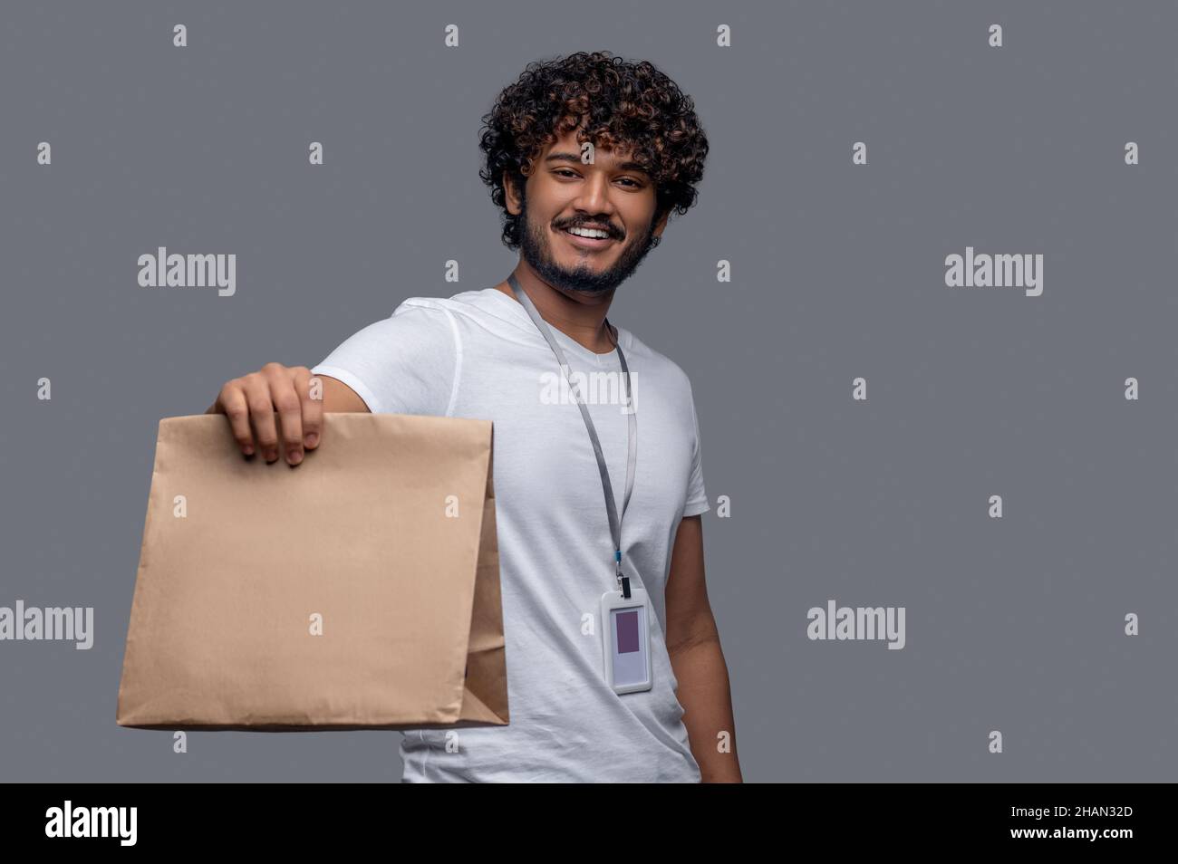 Attractive package delivery man hi-res stock photography and images - Alamy