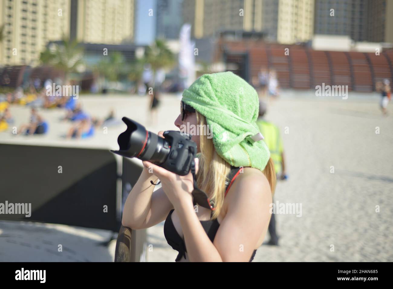 Young woman photographer taking photos outdoor on digital camera at a daytime Stock Photo