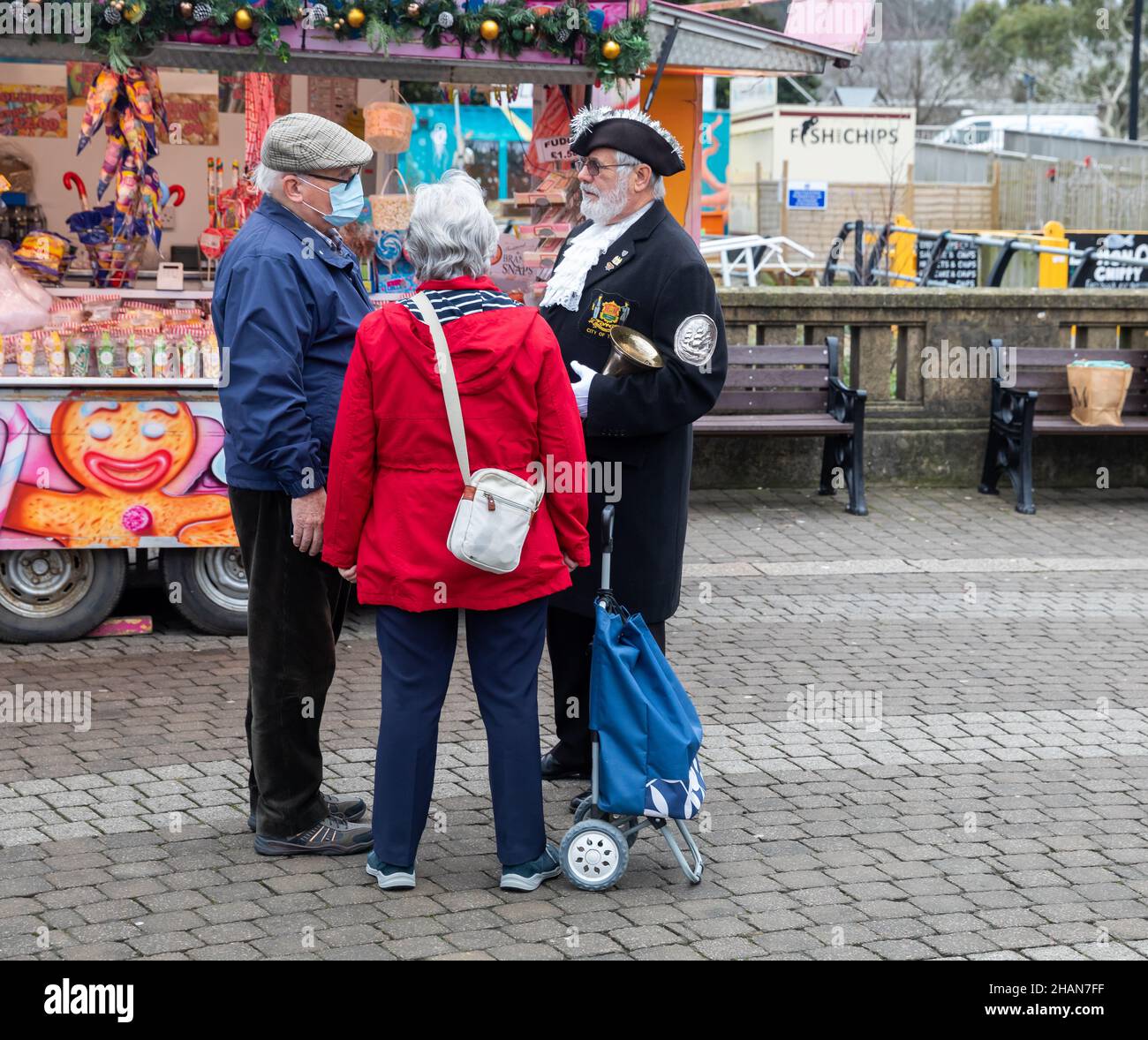 Truro, UK,14th December 2021,Town Crier Lionel Knight stands chatting ...