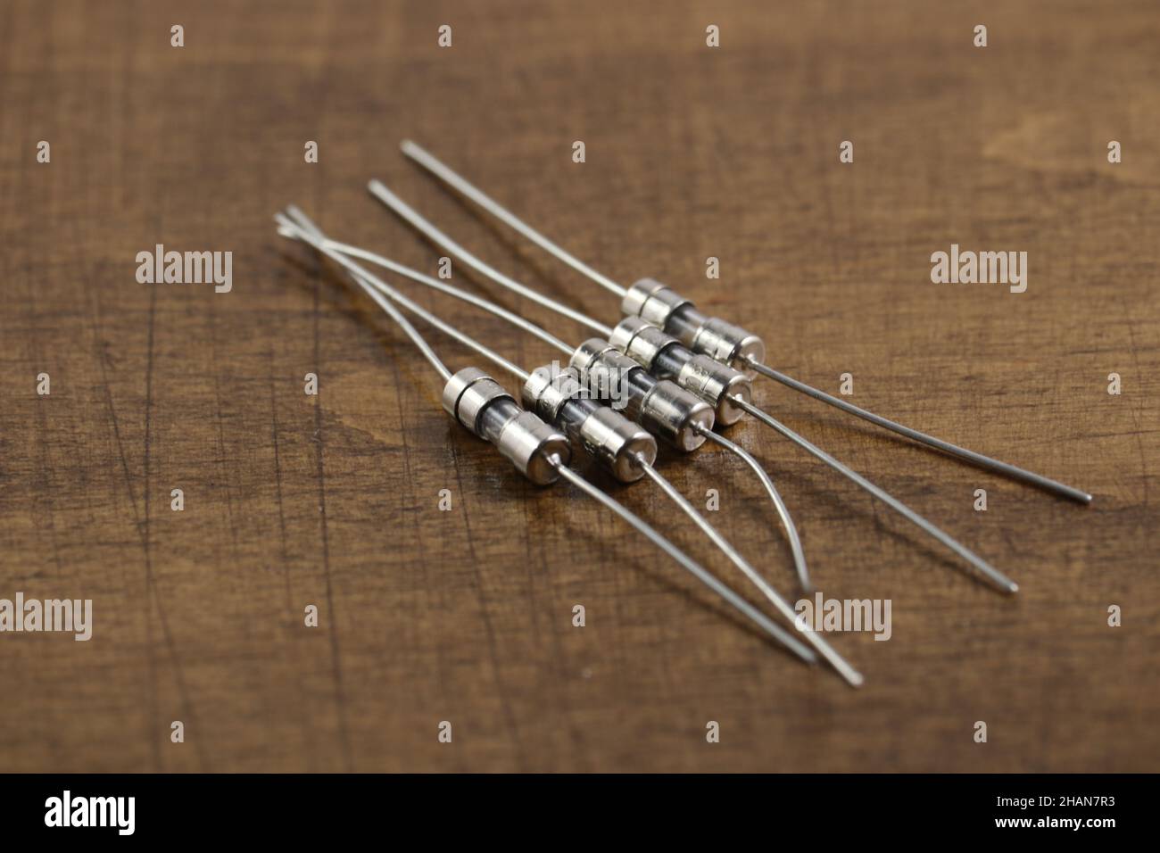 Electronic components a few fuses on wooden table. Twoterminal