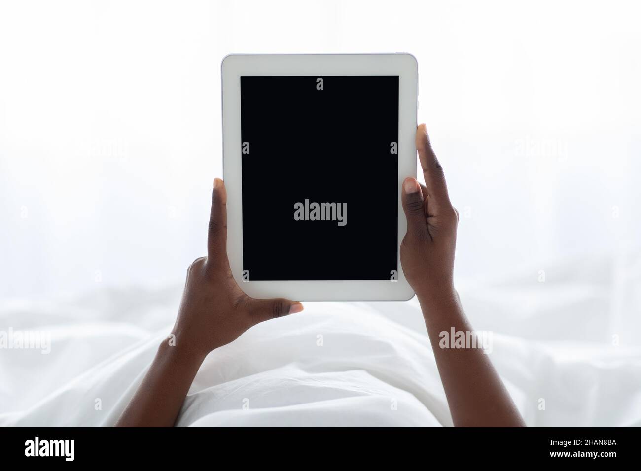Female hands holding digital tablet with empty screen Stock Photo
