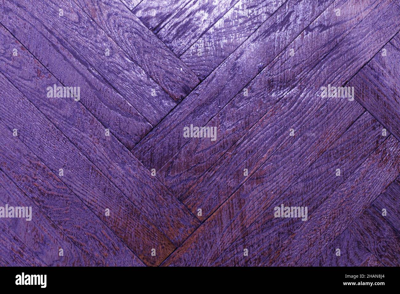 Old wood parquet texture in violet color. Wood purple texture background. Pantone of 2022 Stock Photo