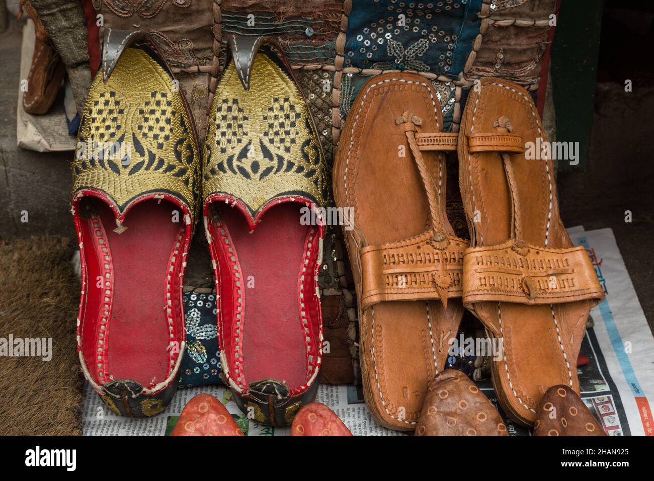 Leather sandals, including a vintage used pair with curled toes, for sale  in a shop on the street in Kathmandu, Nepal Stock Photo - Alamy