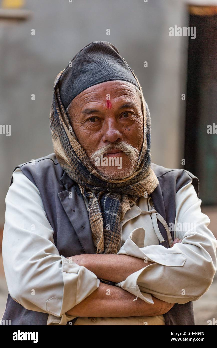 A Nepali man in a dhaka topi hat in the medieval Newari village of