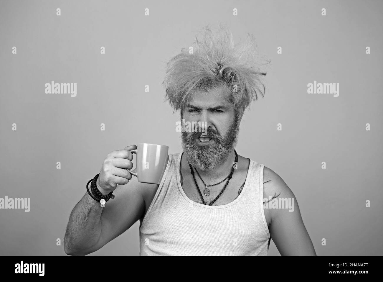 Bearded man trying to wake up in the morning after night out. Stock Photo