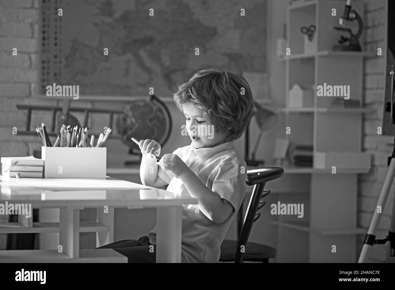 Portrait of little boy sitting in drawing class. Stock Photo