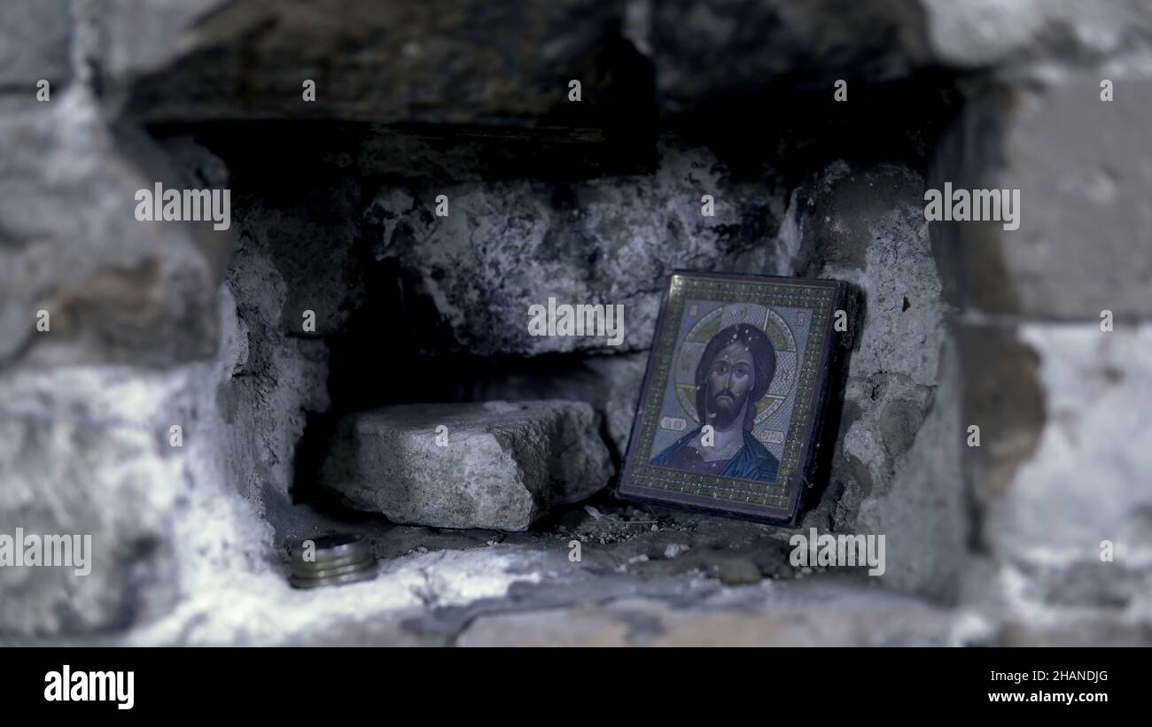 Holy Icon in the rocky wall. Footage. Icon in frame for prayer. Stock Photo