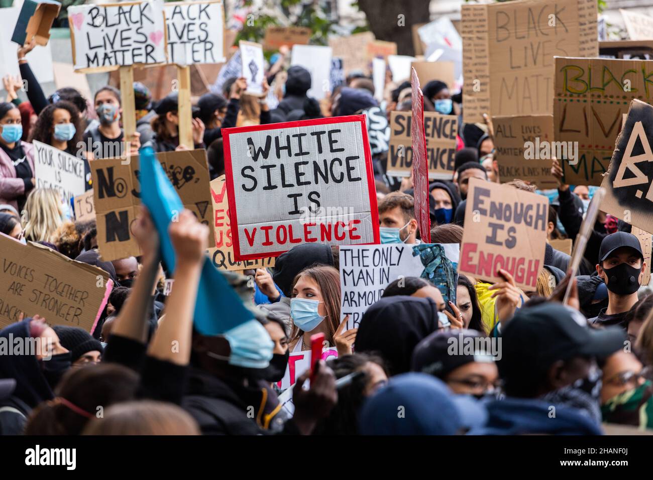 Black Lives Matter Protestors with many placards including white silence is violence London 2020 Stock Photo