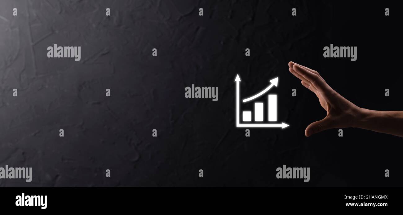 Businessman man holding a graph with positive profits growth. plan ...