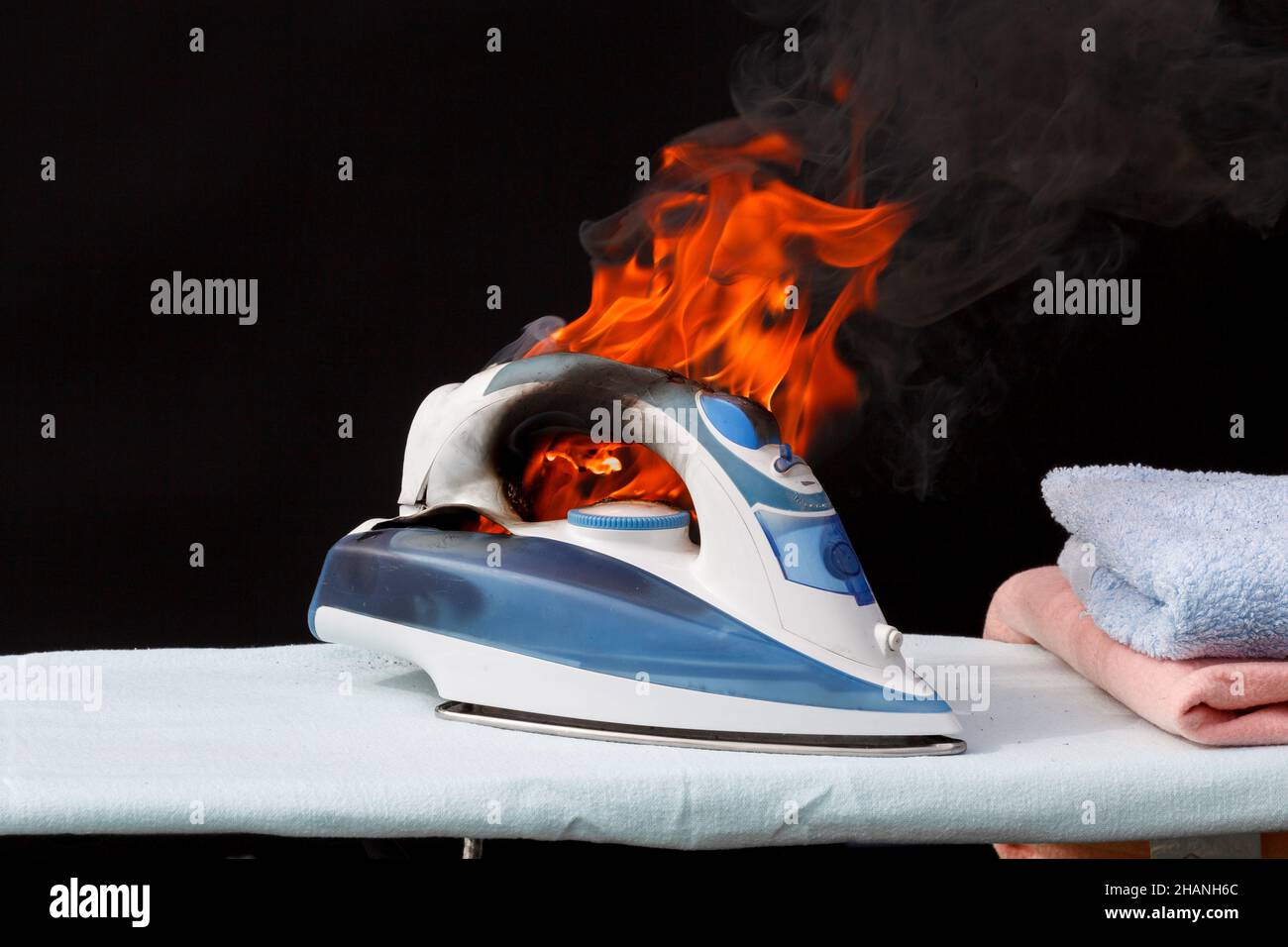 Iron in flames of fire, faulty wiring, cause of fire Stock Photo Alamy