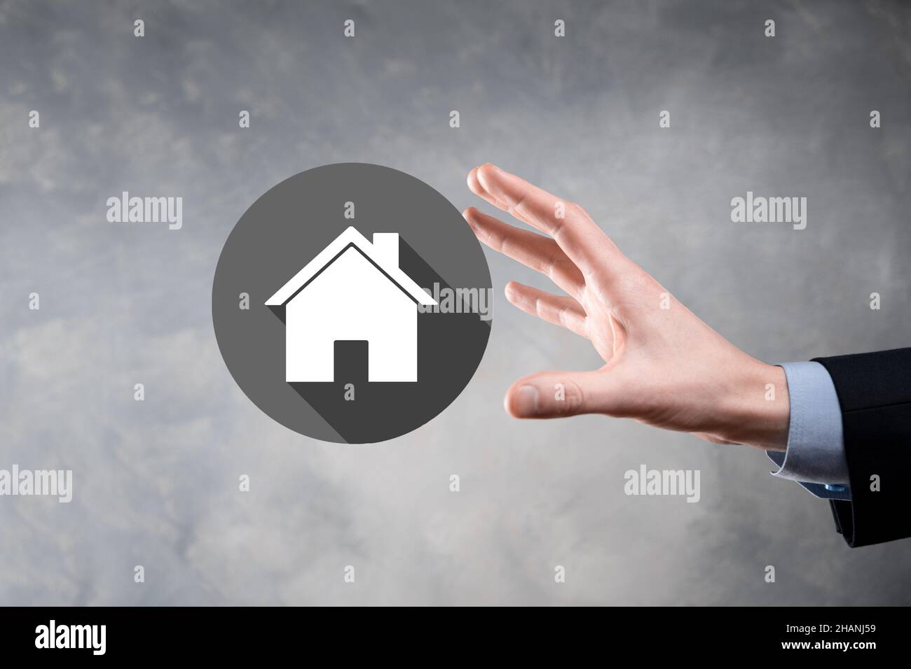 Real estate concept, businessman holding a house icon.House on Hand.Property insurance and security concept. Protecting gesture of man and symbol of h Stock Photo