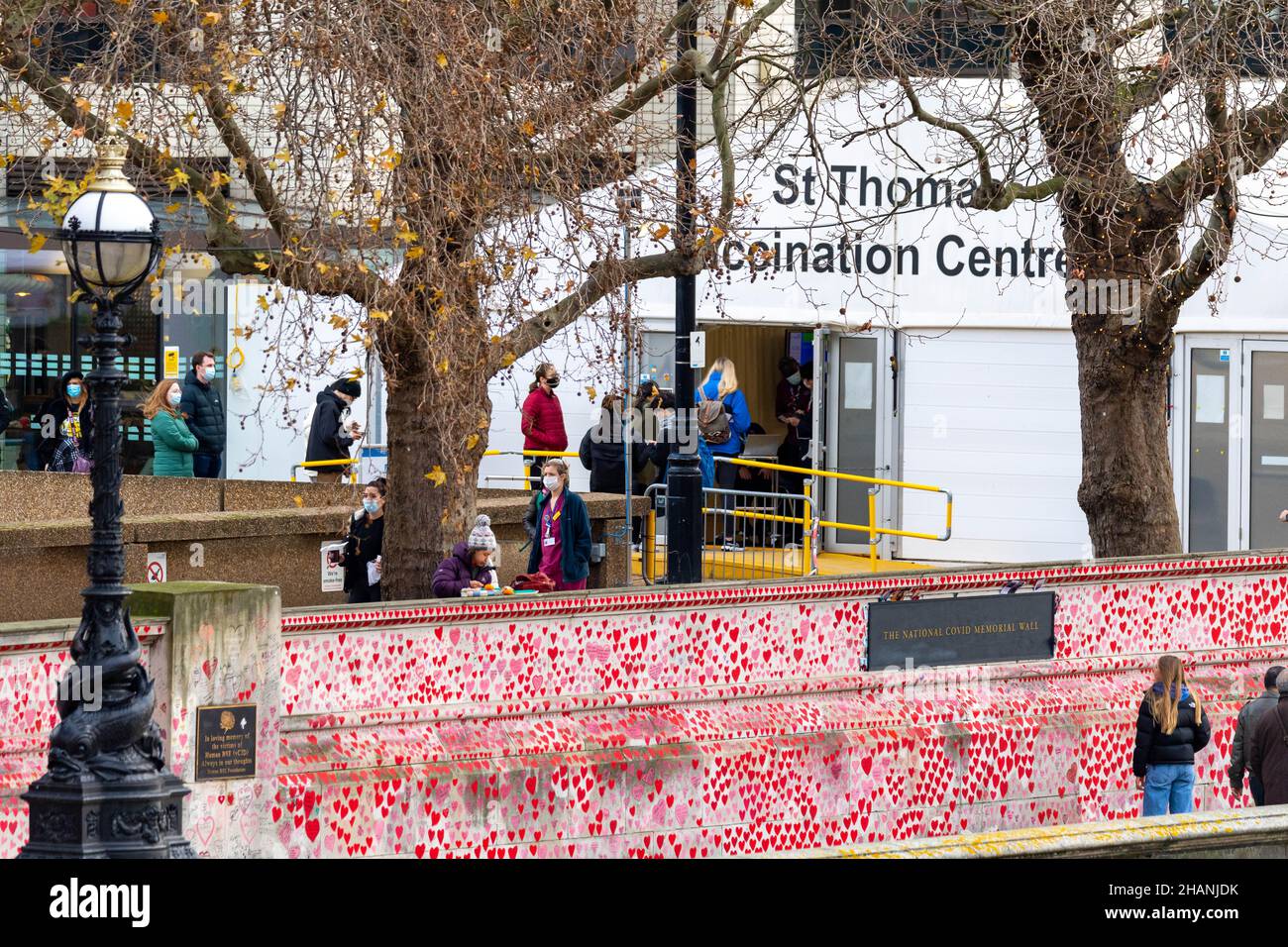 London, UK. 14th Dec, 2021. queues for Covid booster vaccine at St Thomas' hospital Westminster London The National Covid Memorial Wall is in the foreground, Credit: Ian Davidson/Alamy Live News Stock Photo