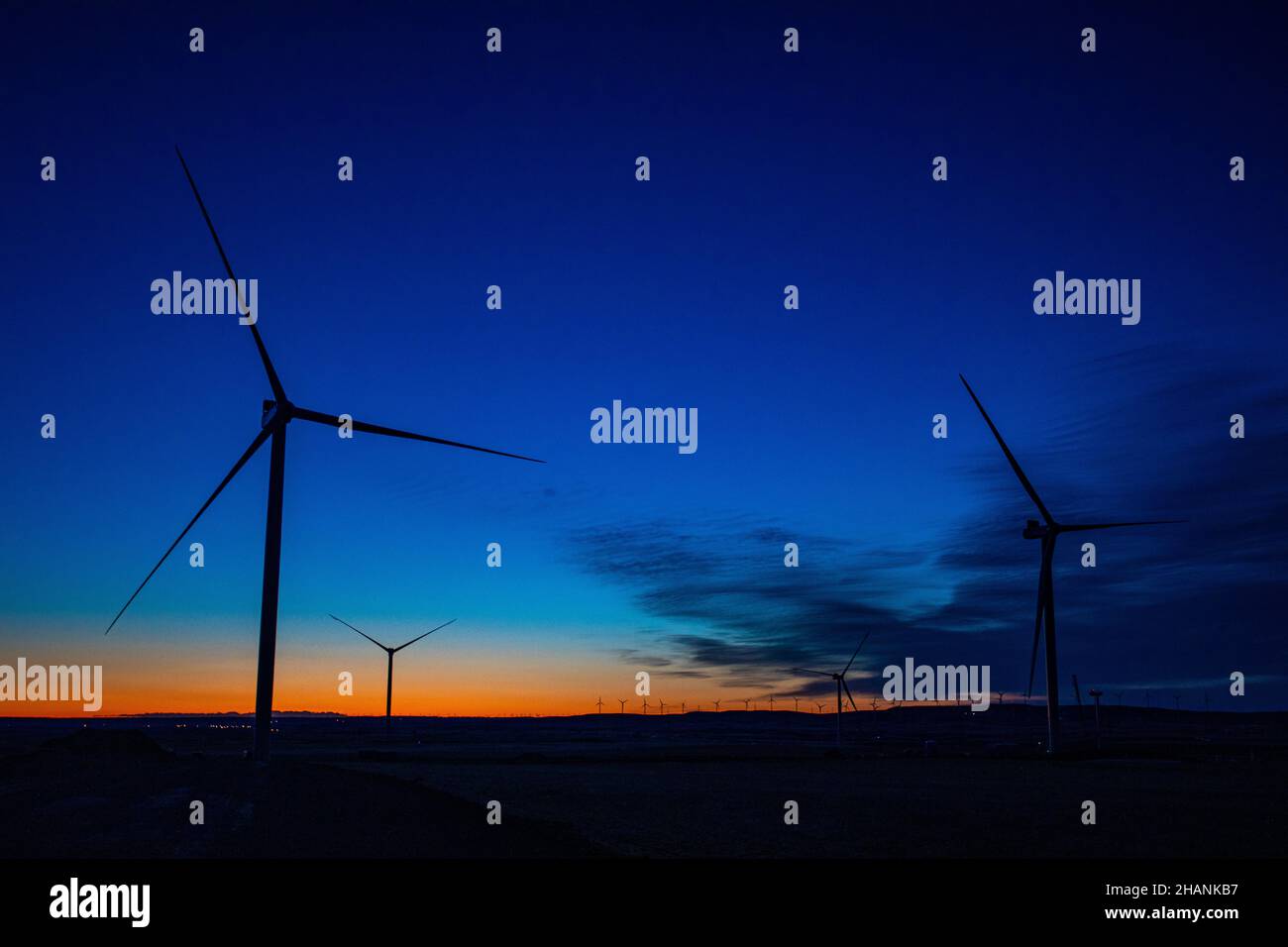 Silhouettes of the wind turbines against the background of sunset Stock ...
