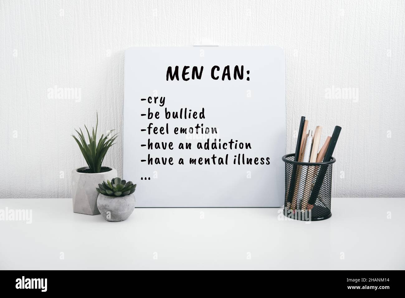 Men Mental Health Care Concept. Letterboard with Mental Health quote Men can cry on table at home. Stock Photo