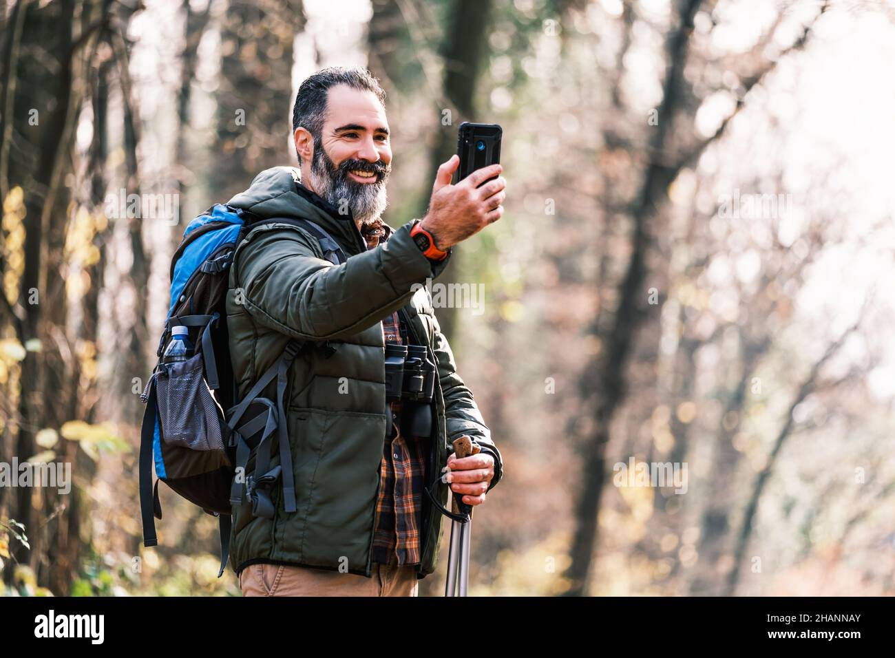 Image of man enjoys hiking and making selfie with his phone Stock Photo ...