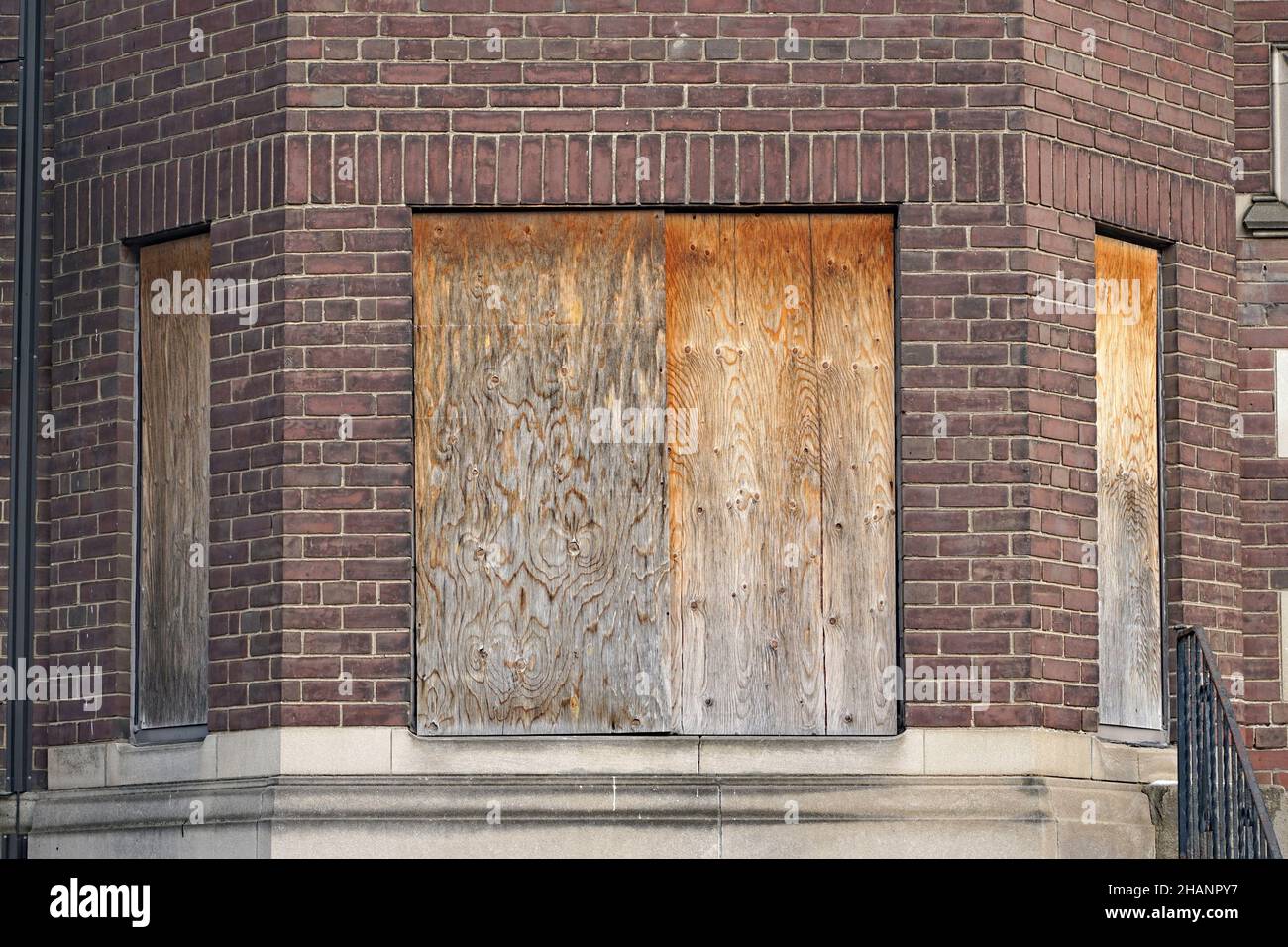 old abandoned apartment building with boarded up windows Stock Photo