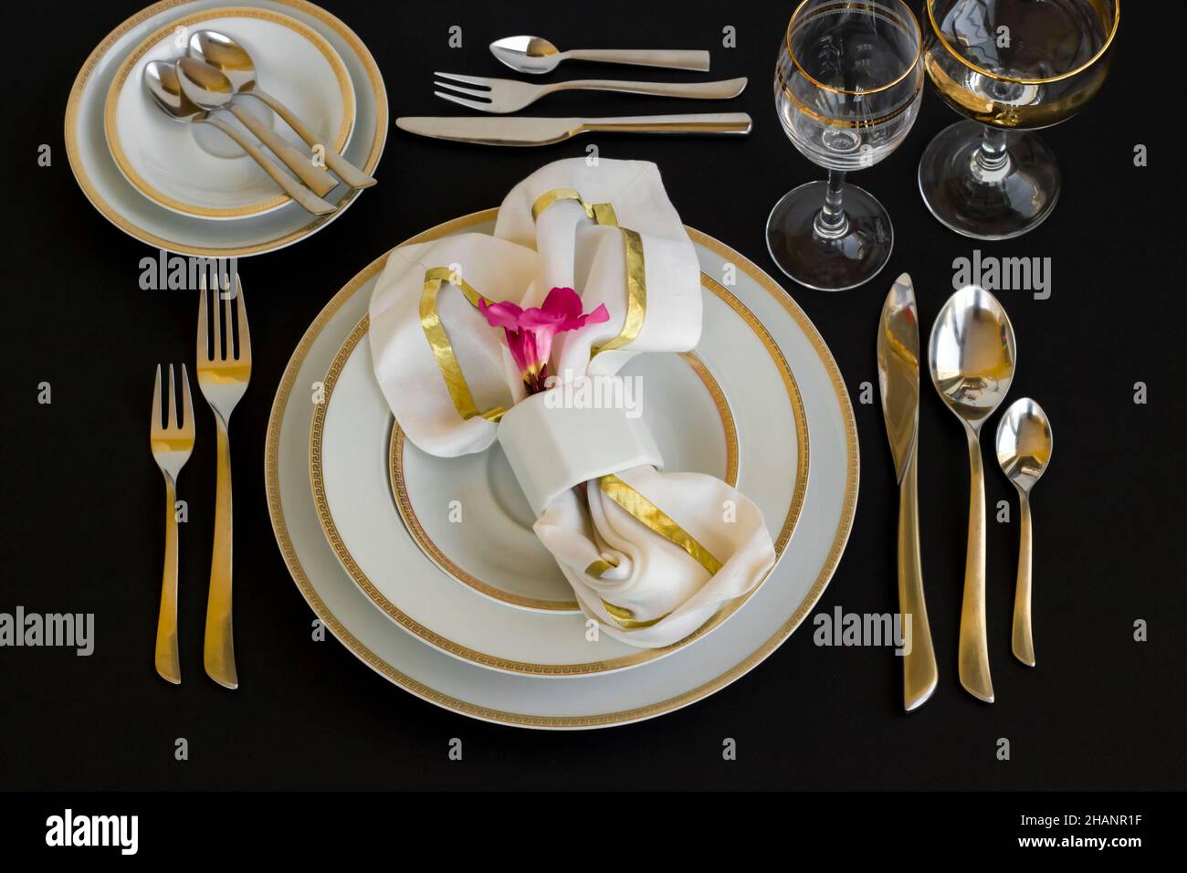 A stylish table without food was designed with elegant utensil on black surface. Stock Photo