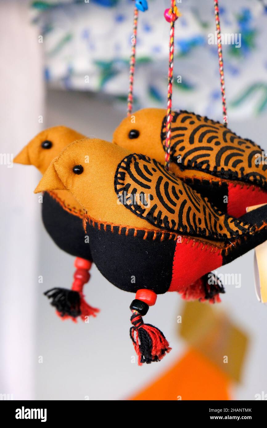 Colourful hanging birds that decorated with colorful handmade clothes