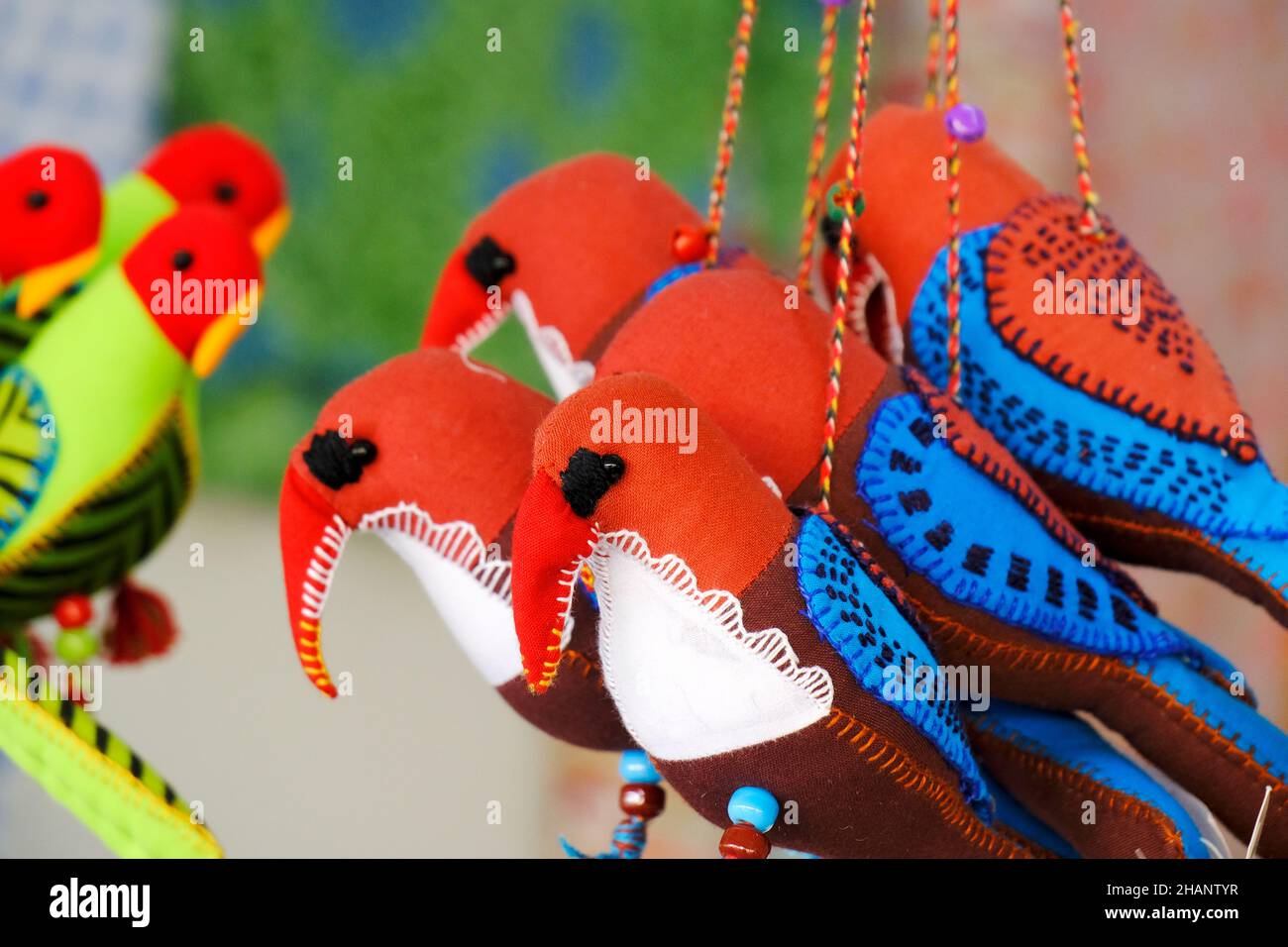 Colourful hanging birds that decorated with colorful handmade clothes