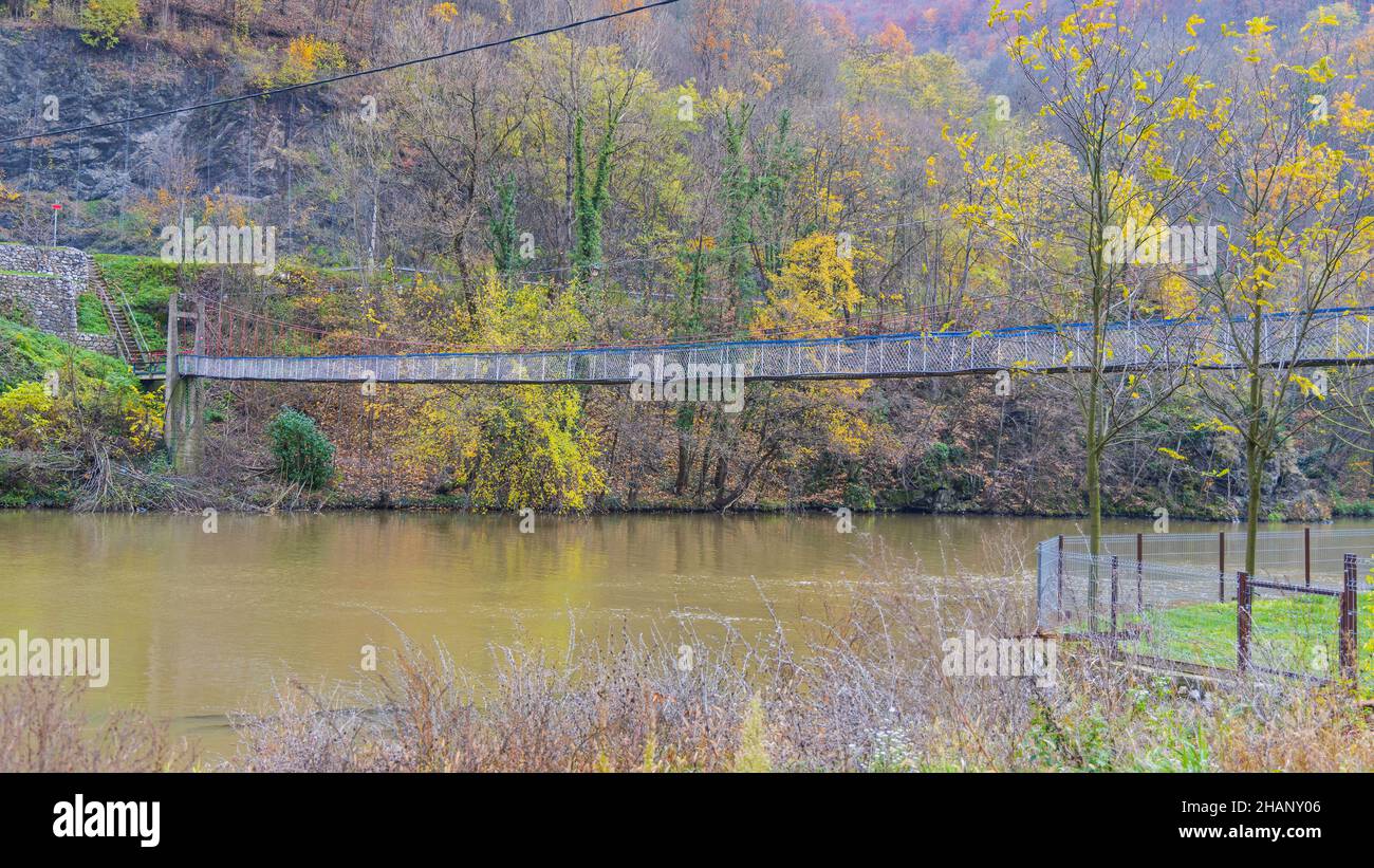 Pedestrian Suspension Bridge Over Small River in West Serbia Autumn Stock Photo
