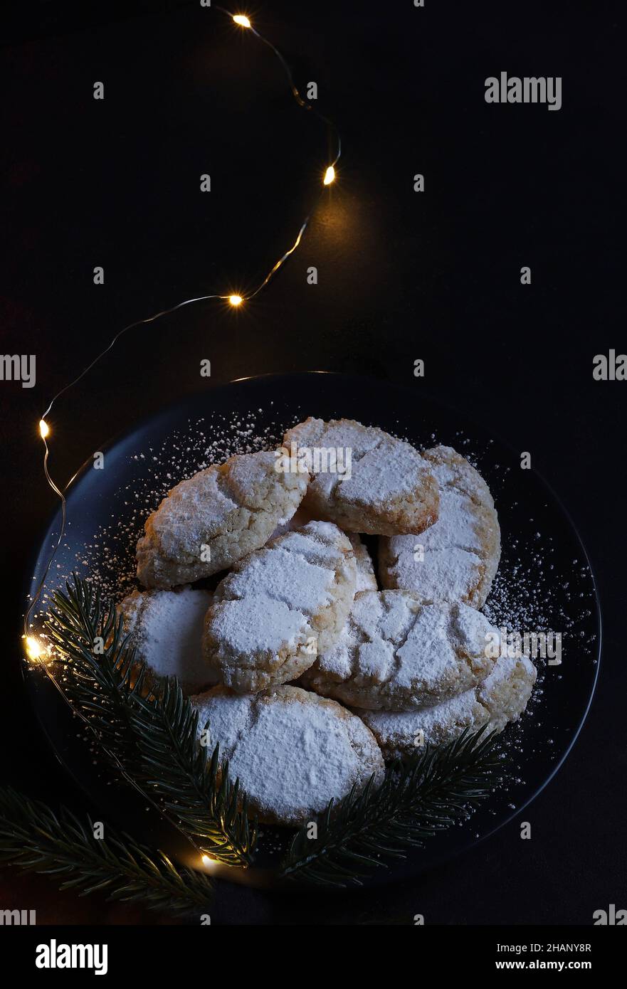 Ricciarelli pastries, typical Sienese Christmas sweet made with almond on dark background. Christmas decorations. Traditional Italian desserts. Stock Photo