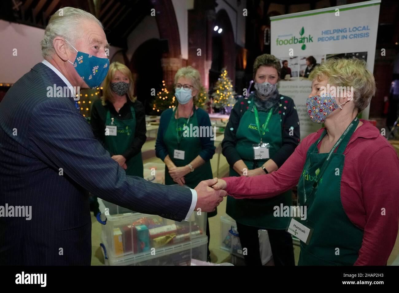 The Prince of Wales speaks to a volunteer during a visit to Wandsworth Foodbank at St. Mark's Church in Battersea Rise, London. Picture date: Tuesday December 14, 2021. Stock Photo