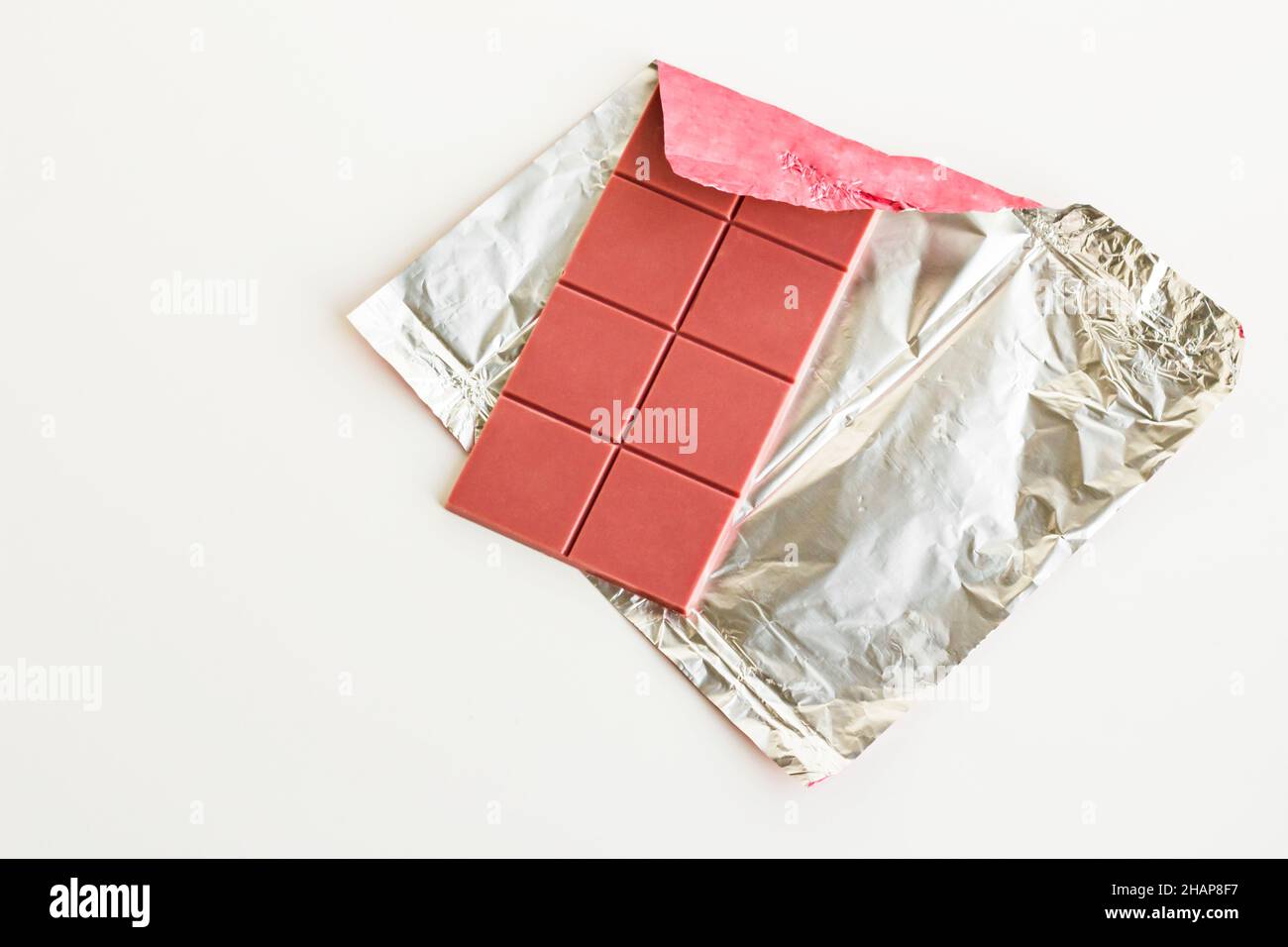 Fourth type in chocolate: Ruby on the aluminum own packagingat white surface with copy space,top view Stock Photo