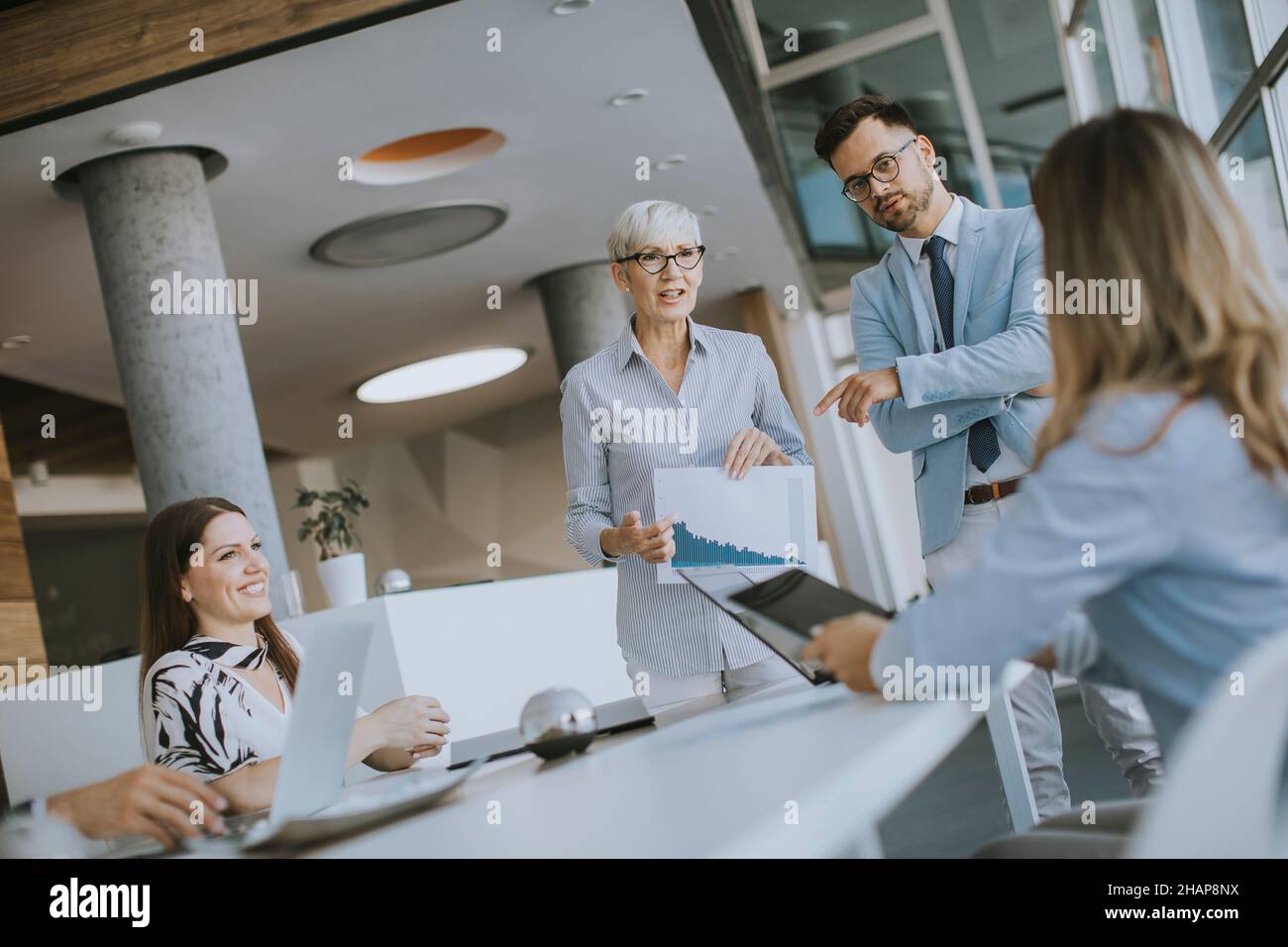 View at mature business woman explaining project details on a meeting in office Stock Photo