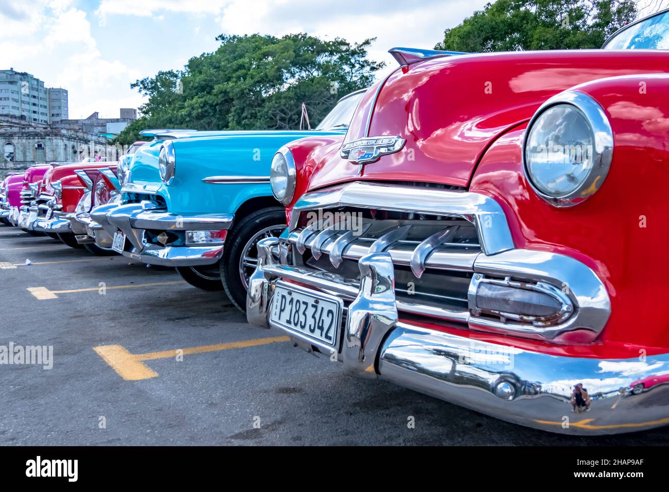 Row of classic Cuban cars of varying colors Stock Photo
