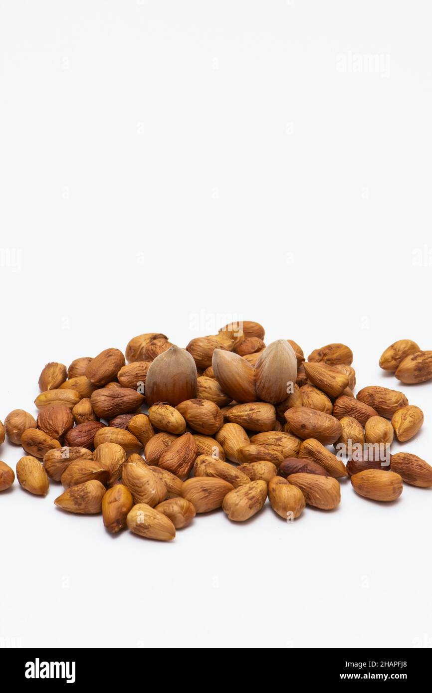 Mixed hazelnuts with shell and without it isolated on white background Stock Photo