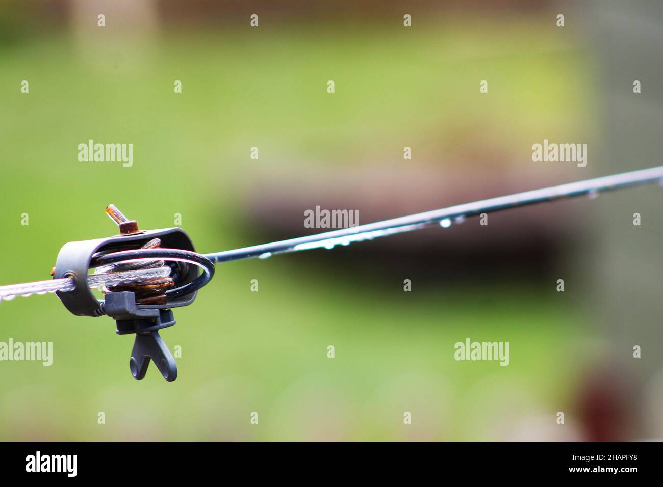 Close-up of a clothesline joiner and tightener, rainwater on clothesline. Stock Photo