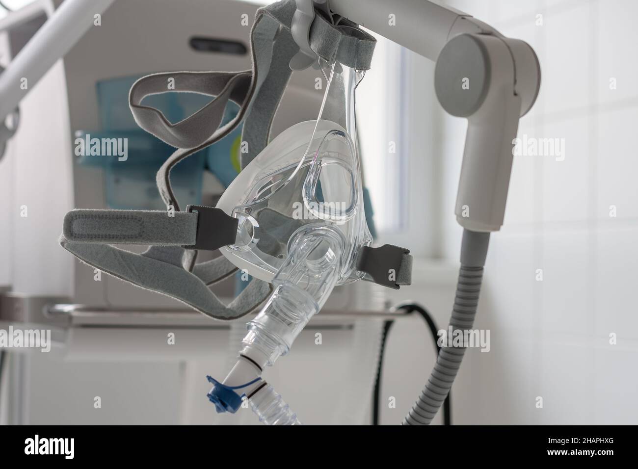 Noninvasive ventilation face mask, on background medical ventilator in ICU in hospital Stock