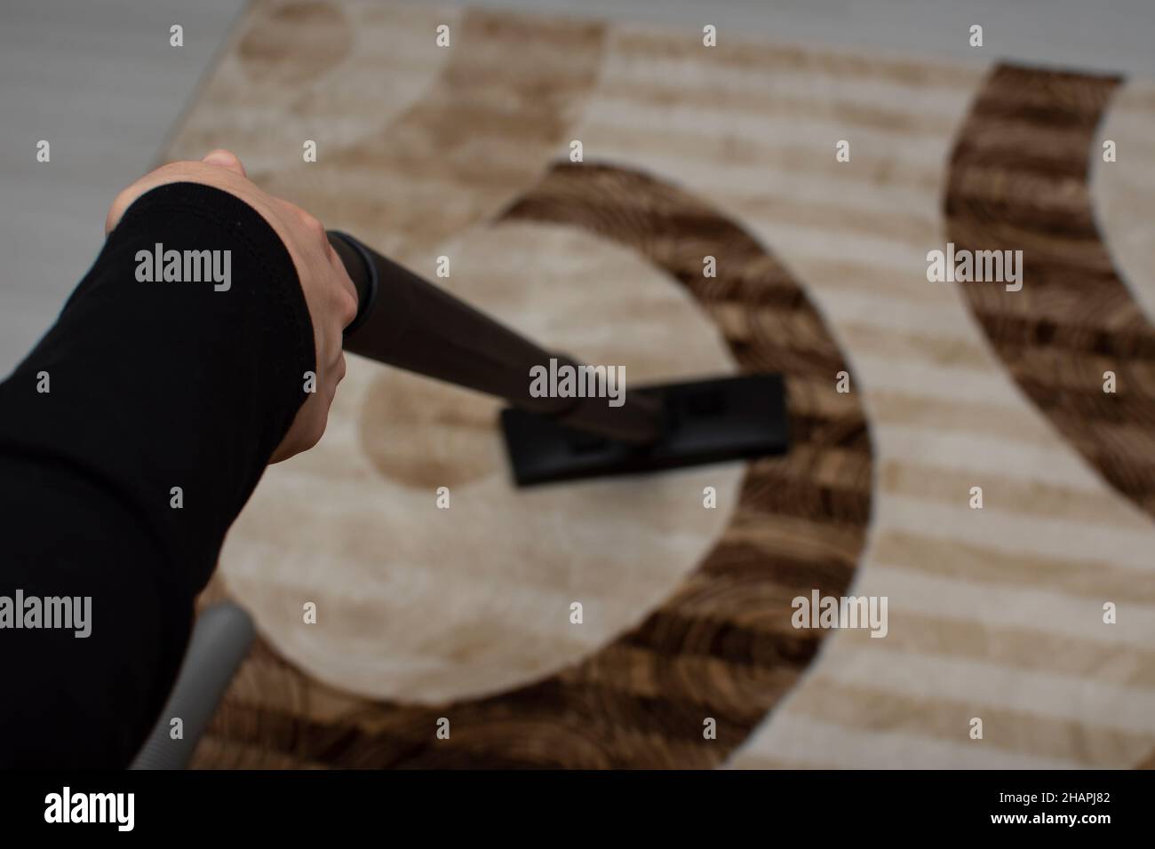 Close up of woman hand while vacuuming the carpet Stock Photo - Alamy
