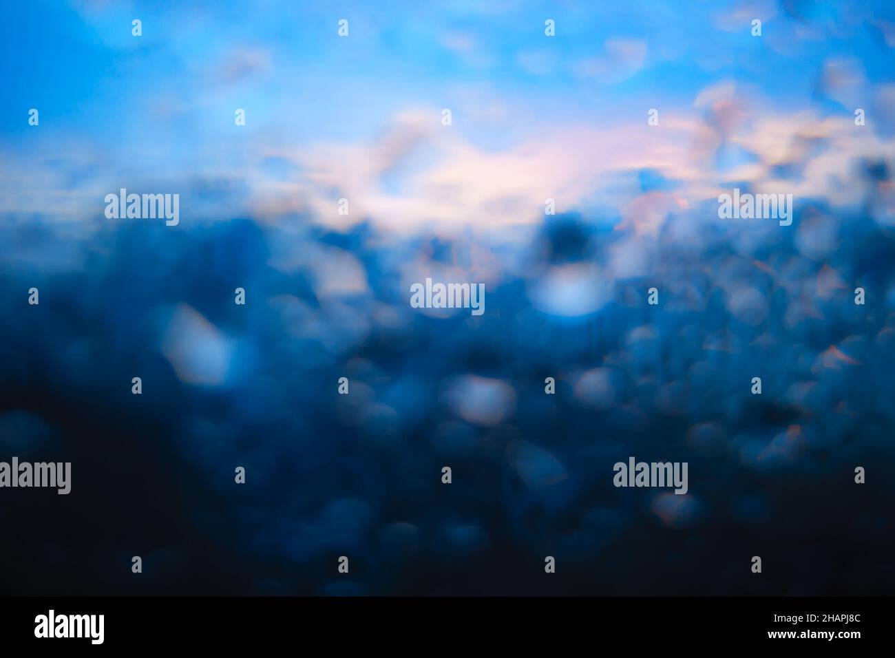Raindrops on window glass bokeh background Stock Photo