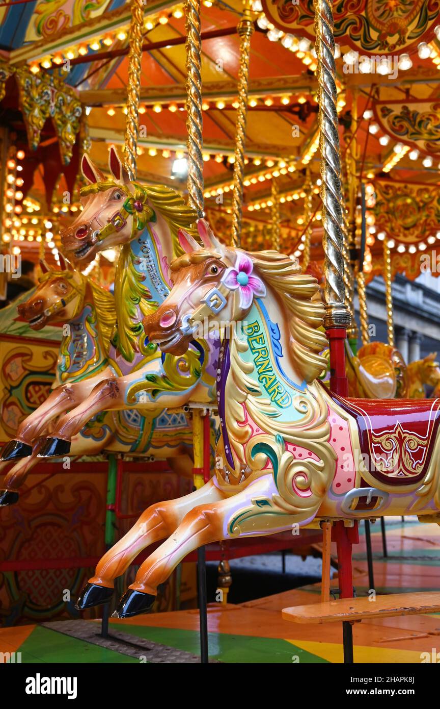 Vintage carousel horse. Outdoor vintage colorful carousel in the the city. Children's Carousel at an amusement park. Stock Photo