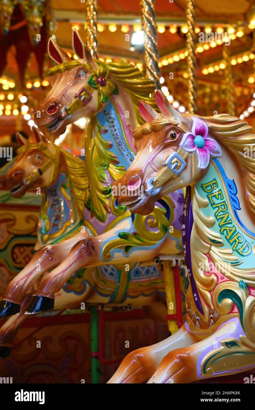 Vintage carousel horse. Outdoor vintage colorful carousel in the the city. Children's Carousel at an amusement park. Stock Photo