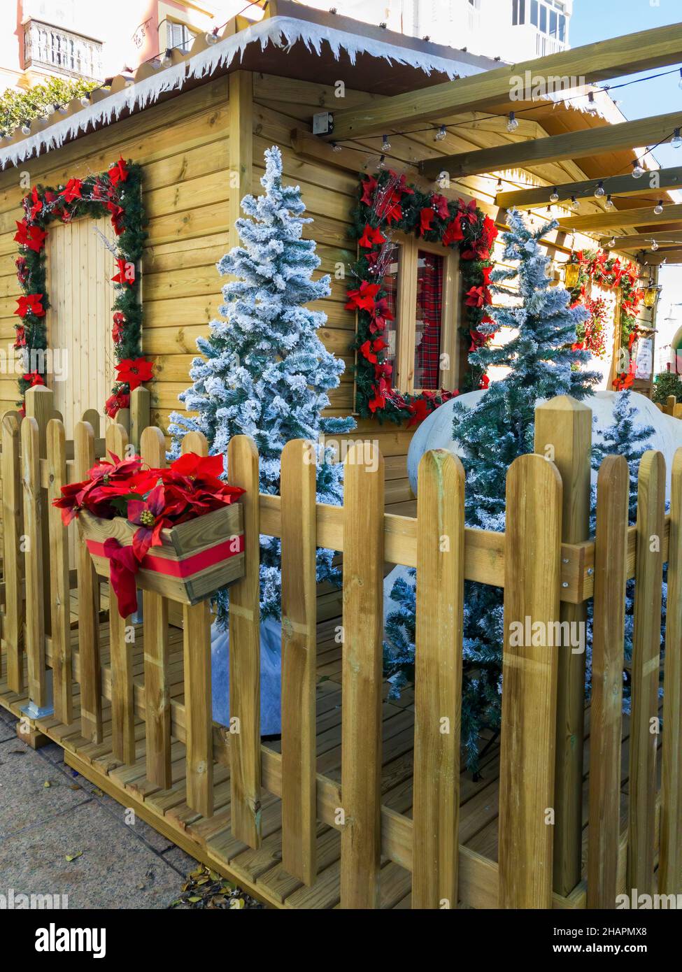 Traditional wooden cabin decorated with Christmas motifs. Stock Photo
