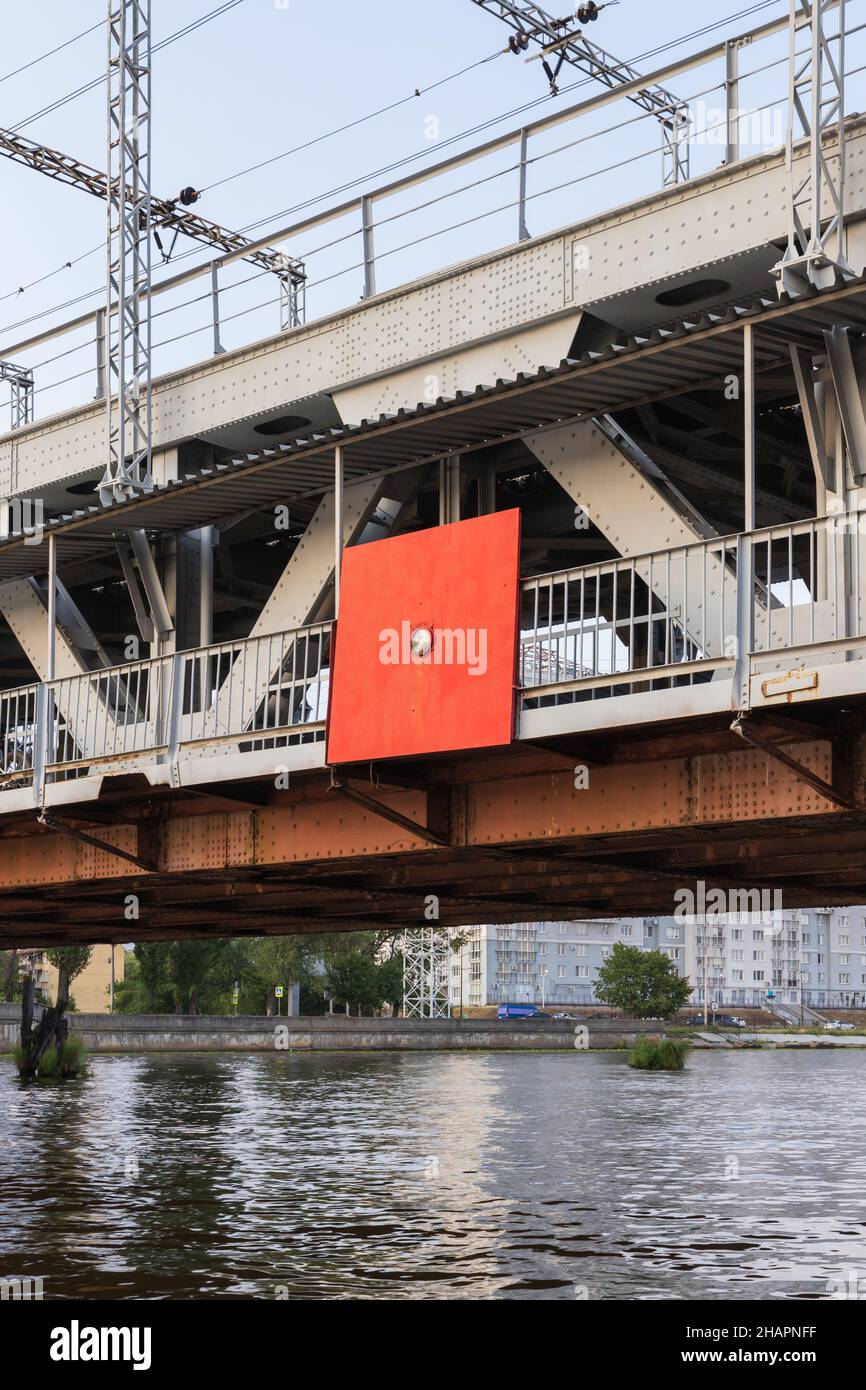 Red navigation sign mounted on a bridge span Stock Photo