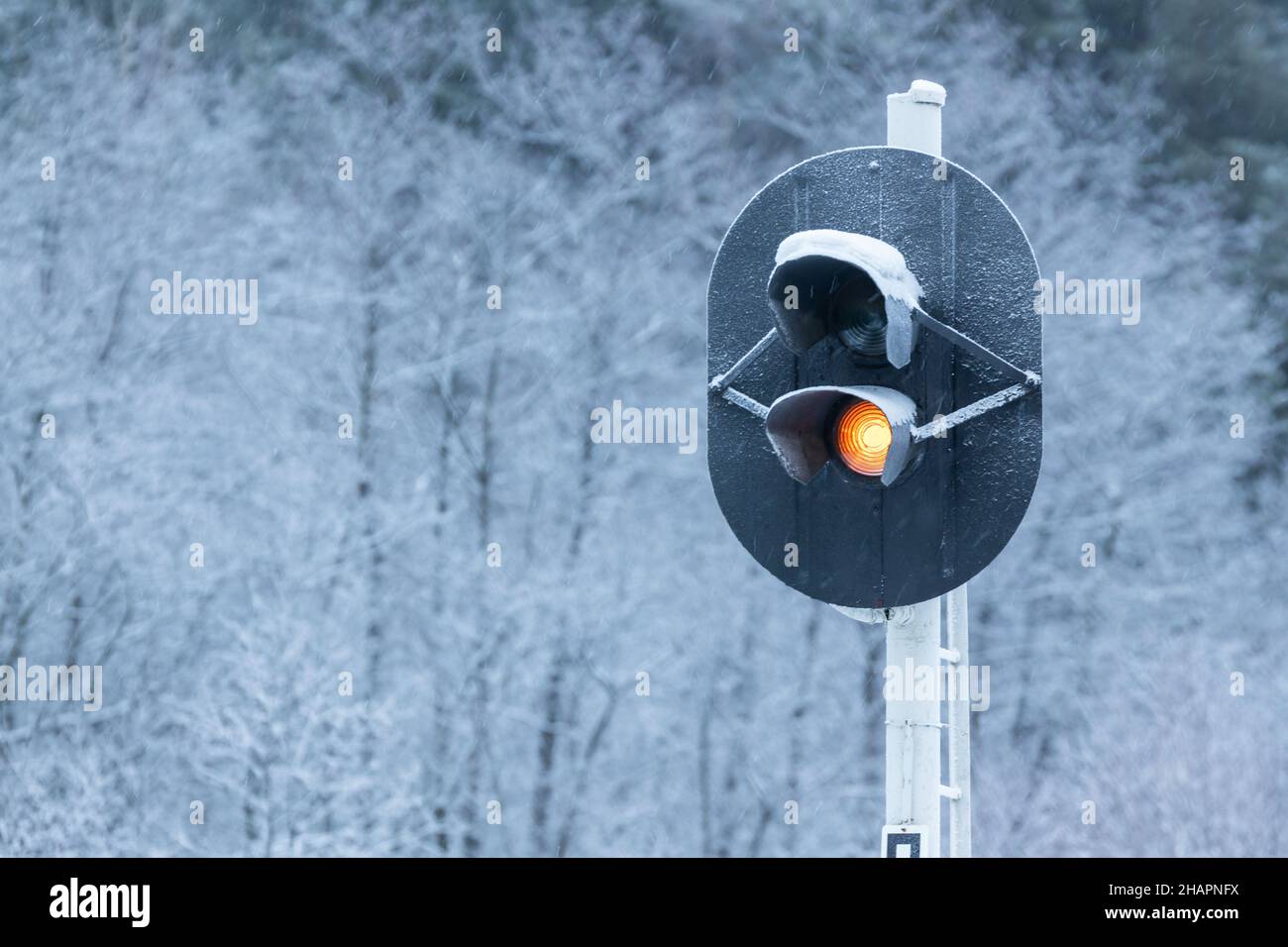 Colour-light signals show danger  red light, close up photo taken on a cold snowy day Stock Photo