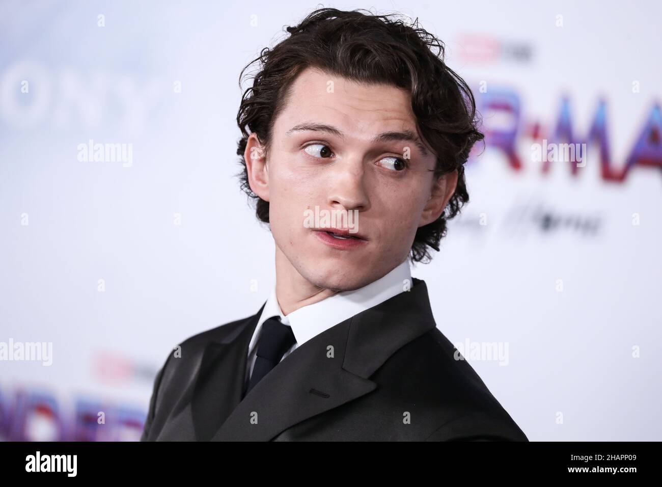 WESTWOOD, LOS ANGELES, CALIFORNIA, USA - DECEMBER 13: Actor Tom Holland  wearing a Prada suit and Christian Louboutin shoes arrives at the Los  Angeles Premiere Of Columbia Pictures' 'Spider-Man: No Way Home'