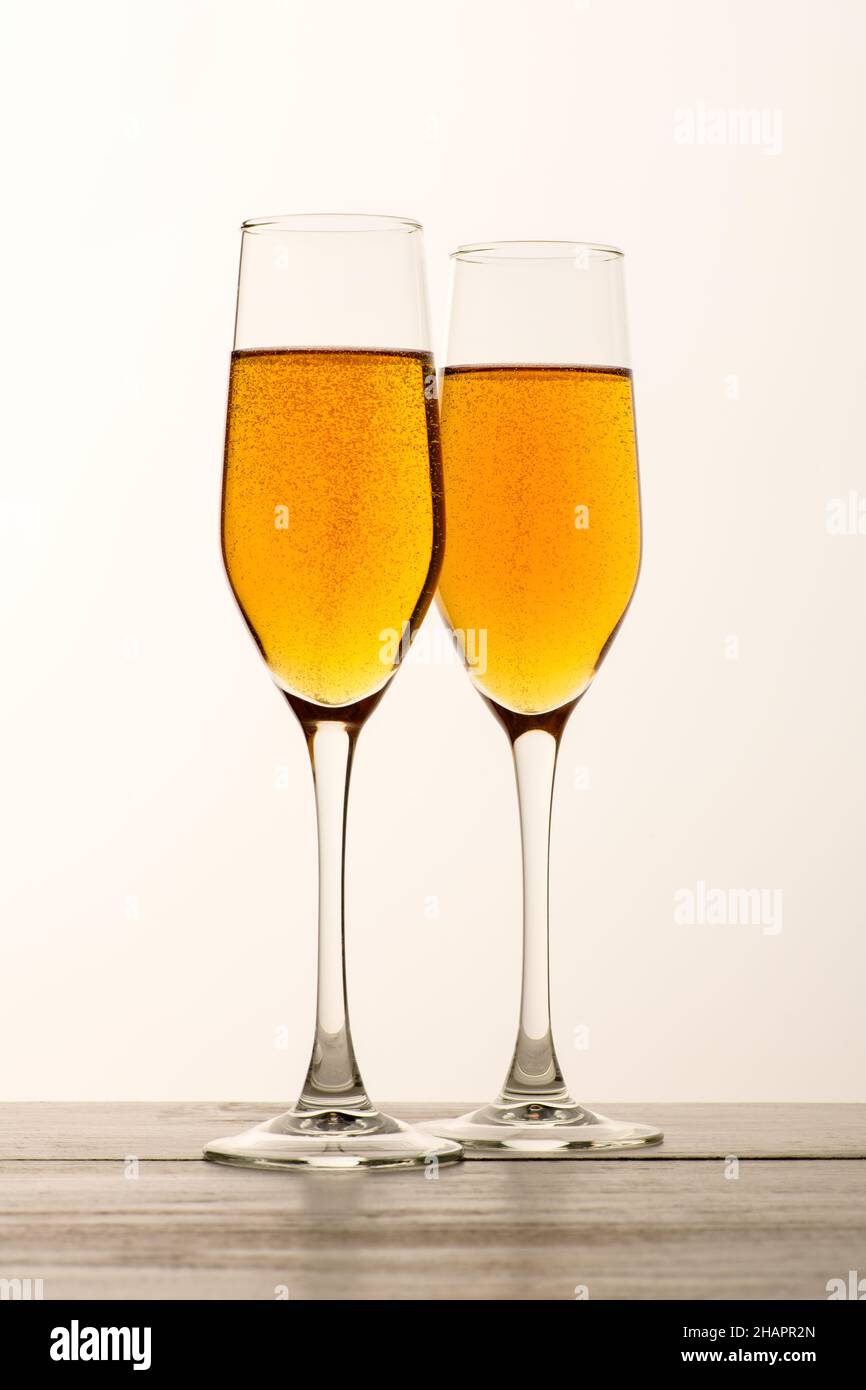 Two glasses of champagne, wine with bubbles on gray background. Alcoholic drink: champagne, beer, white wine. New year and Christmas background Stock Photo