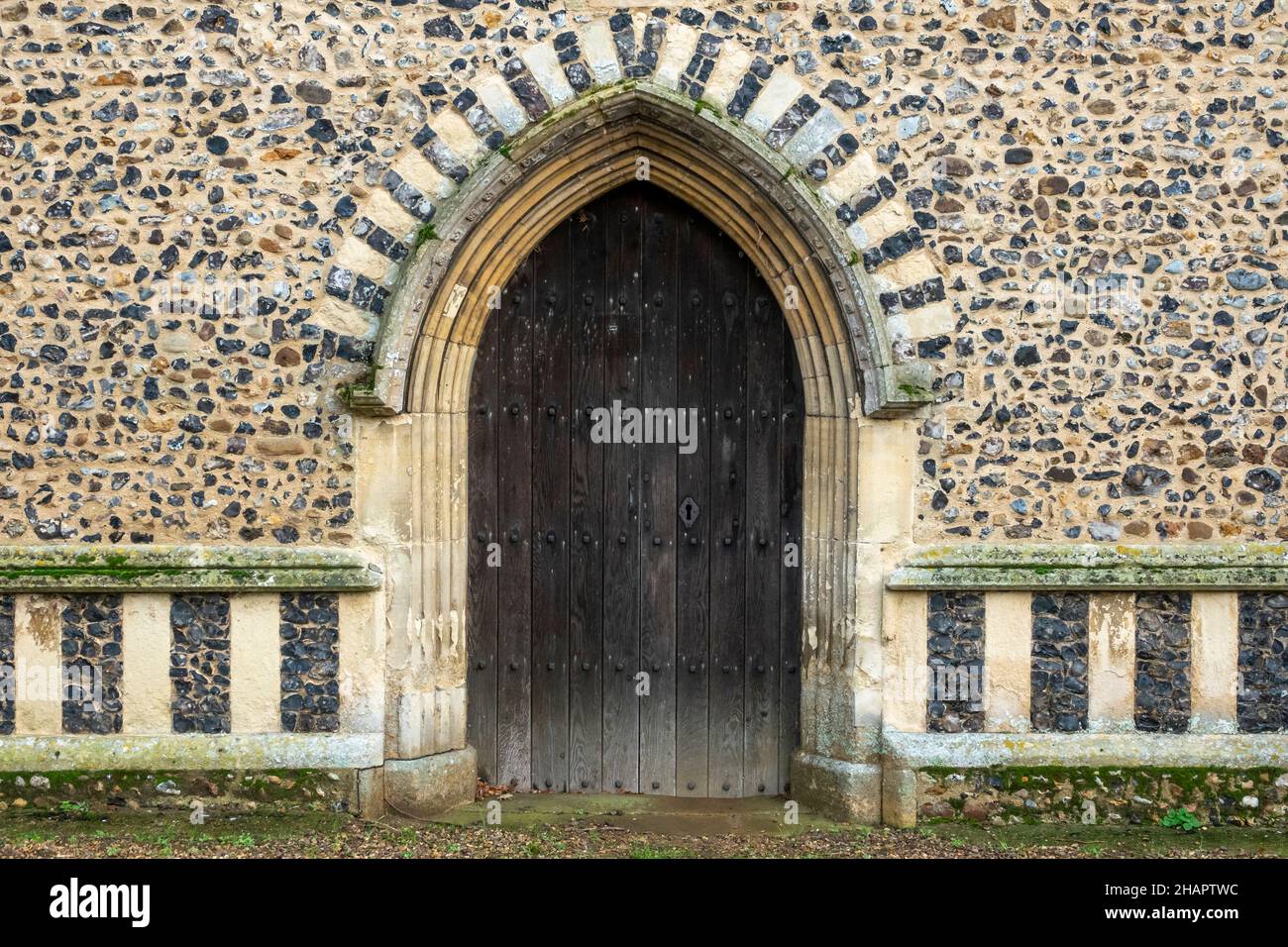 Decorated flushwork doorway surround at the Church of St Mary of the Assumption, Ufford, Suffolk Stock Photo