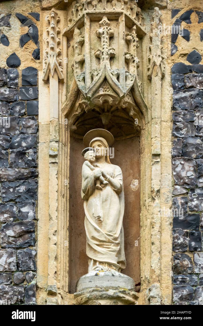 Mary one of the niche statues over the doorway in the porch of St Mary of the Assumption, Ufford, Sussex Stock Photo
