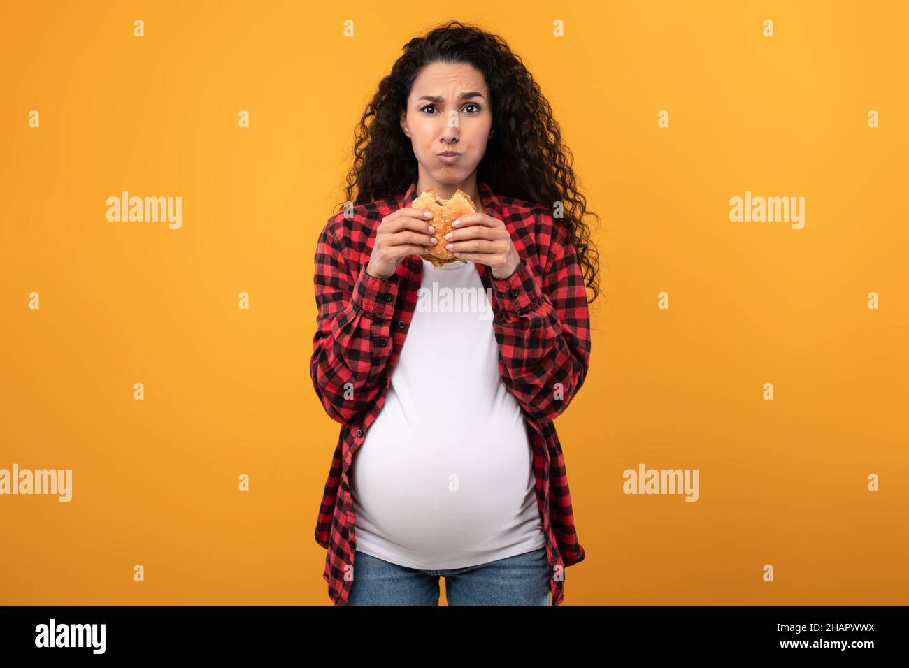 Pregnant Lady Holding Eating Burger At Studio Stock Photo Alamy
