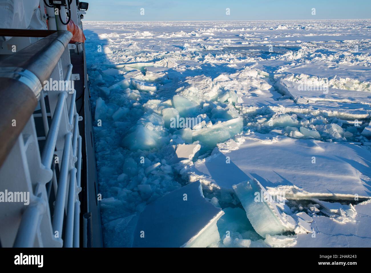 High Arctic, Le Commandant Charcot sailing through thick ice in polar landscape, green LNG icebreaker. Stock Photo