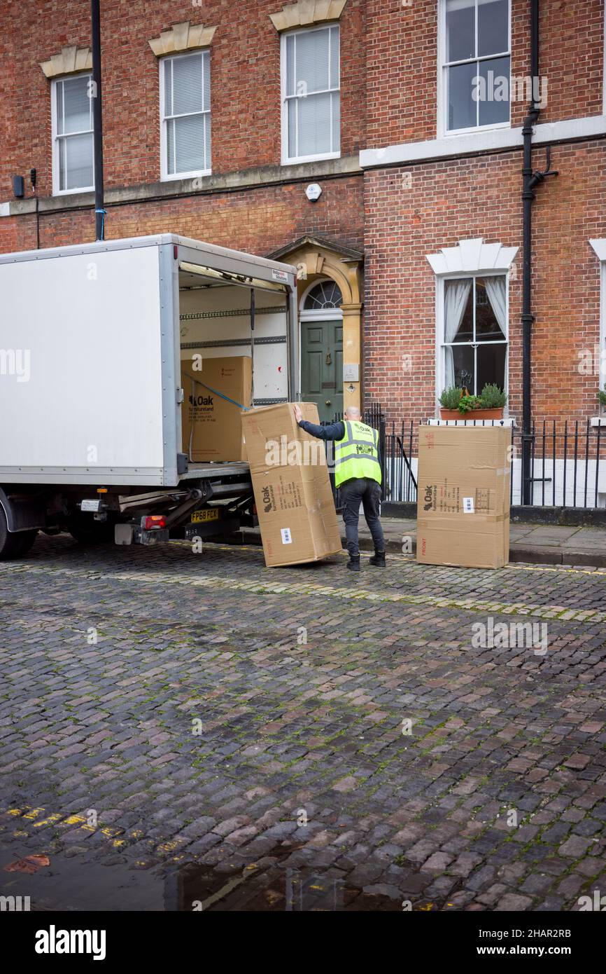 Oak Furniture Land delivery man unloading boxes from his truck (Dec 21) Stock Photo