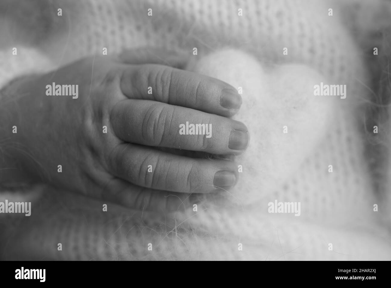 Soft hands of new born hold woolen heart. Fingers of a newborn baby hands Stock Photo Alamy