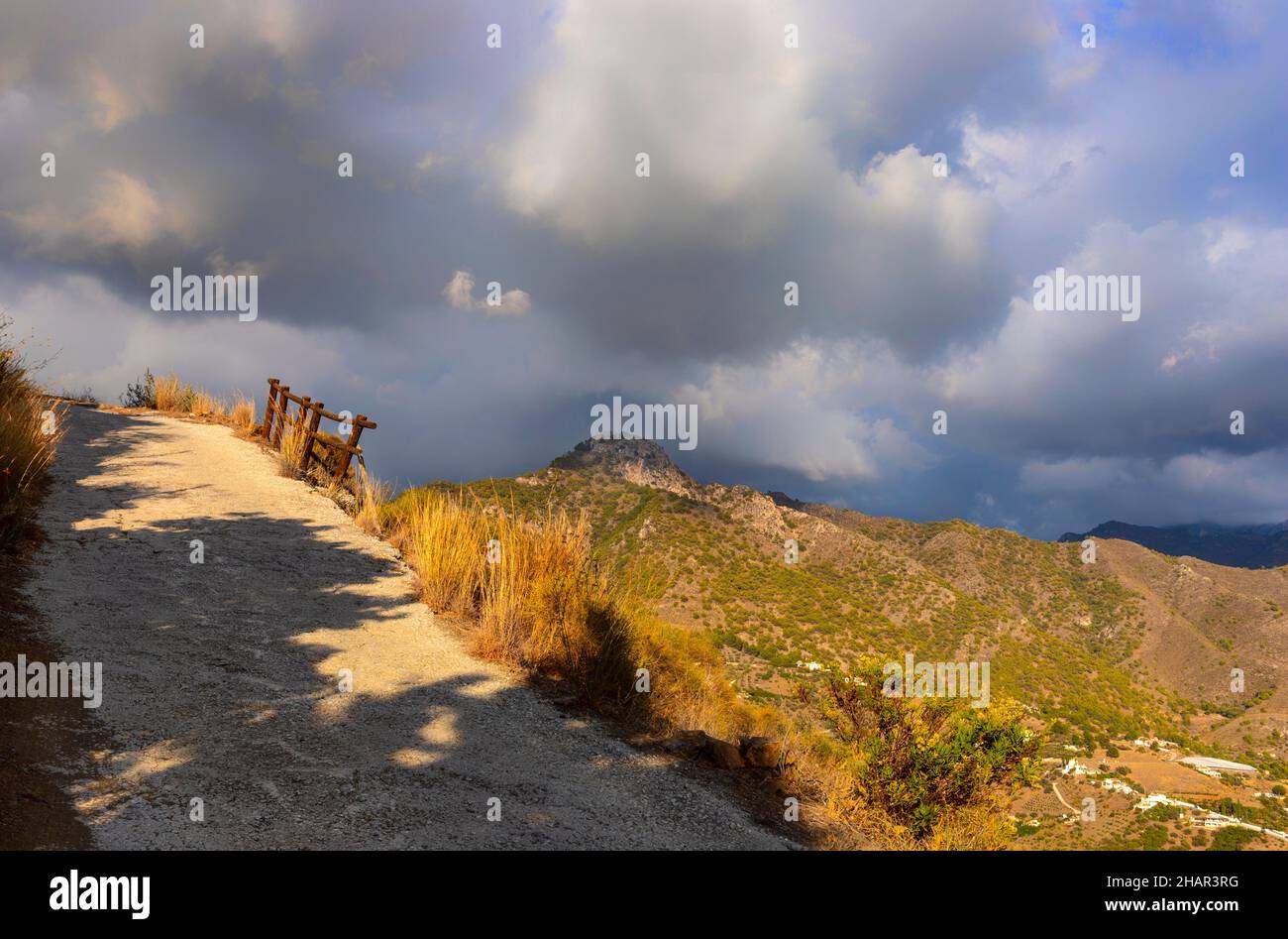Country road with the distant El Fuerte mountain, part of the Sierra de Almijara, malaga Province, Andalucia, Spain Stock Photo